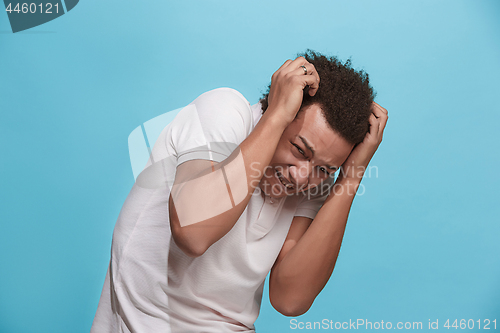 Image of Portrait of the scared man on blue