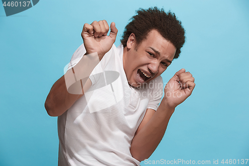 Image of Portrait of the scared man on blue