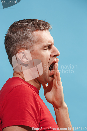 Image of Beautiful bored man bored isolated on blue background