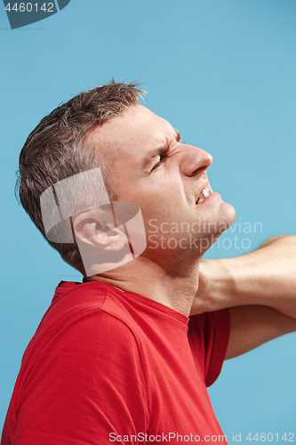 Image of Young man overwhelmed with a pain in the neck .