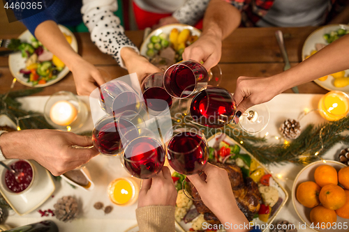 Image of close up of friends with wine celebrate christmas