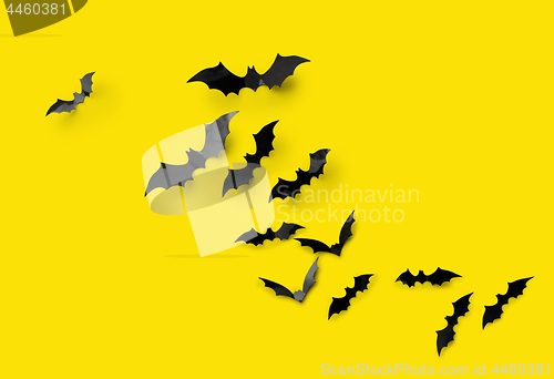 Image of black halloween bats on yellow background