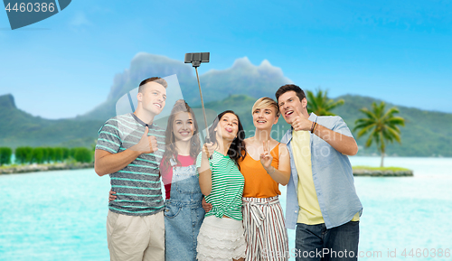 Image of friends taking selfie by smartphone over bora bora