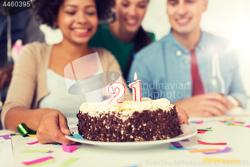 Image of team greeting coworker at office birthday party