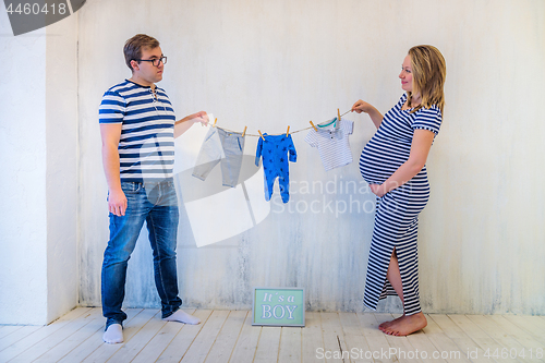 Image of Young couple: pregnant woman and man