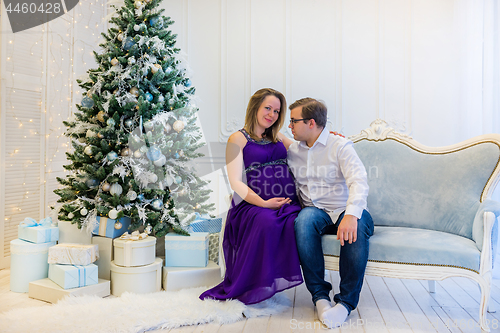 Image of Family portrait near christmas tree