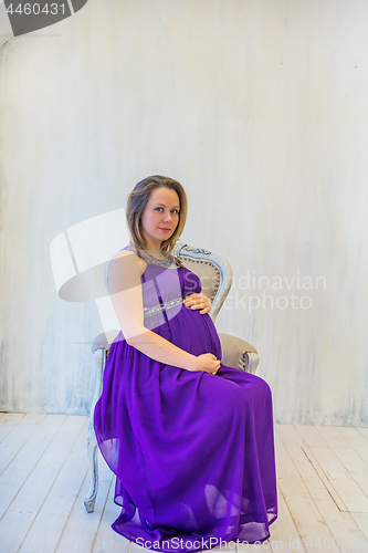 Image of Beautiful pregnant woman sitting