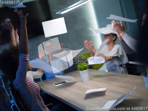 Image of multiethnic Group of young business people throwing documents