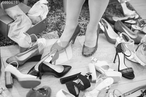 Image of woman sitting in shoe store