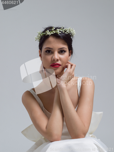 Image of young bride sitting in a wedding dress