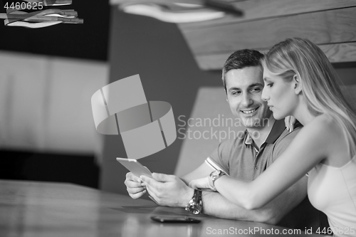 Image of couple using tablet at home