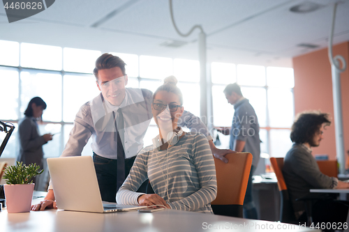 Image of Two Business People Working With laptop in office