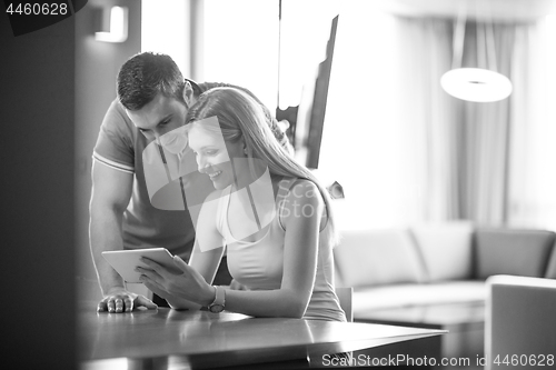 Image of couple using tablet at home