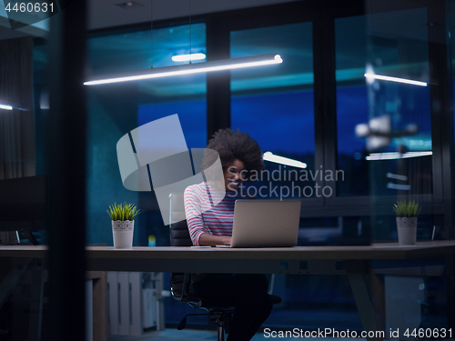 Image of black businesswoman using a laptop in startup office