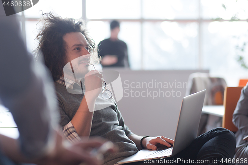 Image of businessman working using a laptop in startup office