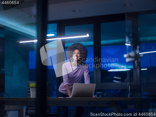 Image of black businesswoman using a laptop in startup office