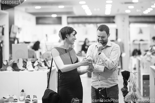 Image of couple chooses shoes At Shoe Store