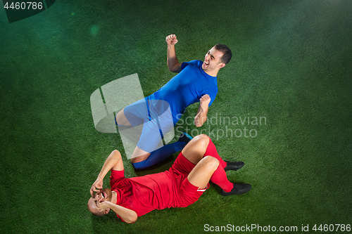 Image of Happy and unhappy football players after goal