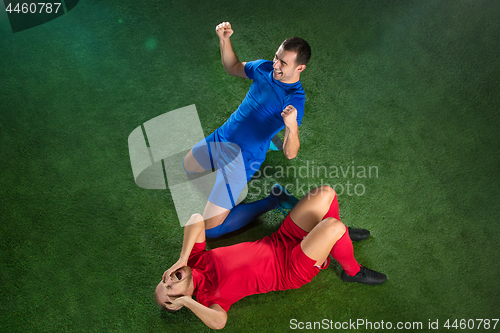 Image of Happy and unhappy football players after goal