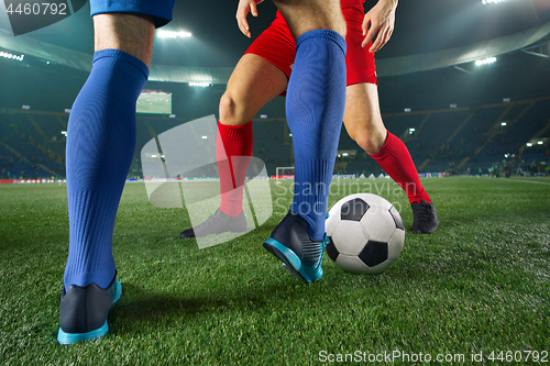 Image of Football players and ball-fighting over green grass