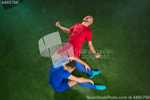 Image of Happy and unhappy football players after goal