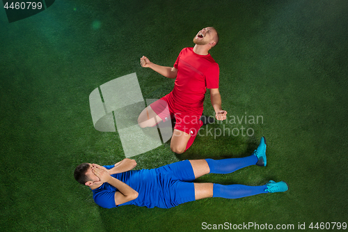 Image of Happy and unhappy football players after goal