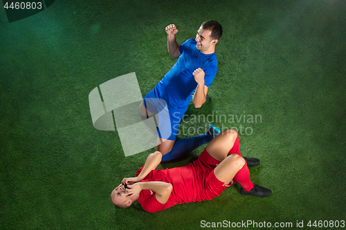 Image of Happy and unhappy football players after goal