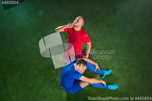 Image of Happy and unhappy football players after goal