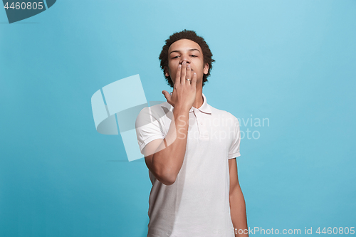 Image of Portrait of attractive afro man with kiss isolated over blue background
