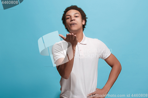 Image of Portrait of attractive afro man with kiss isolated over blue background
