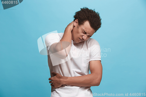 Image of Young man overwhelmed with a pain in the necks