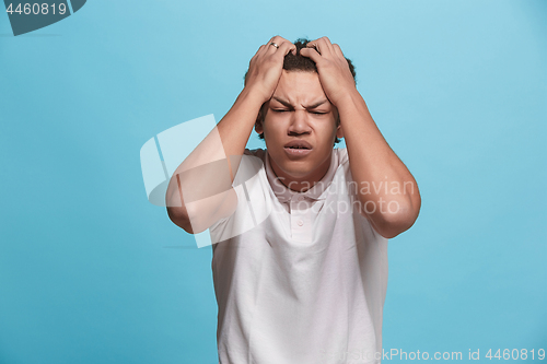 Image of Beautiful man looking suprised and bewildered isolated on blue