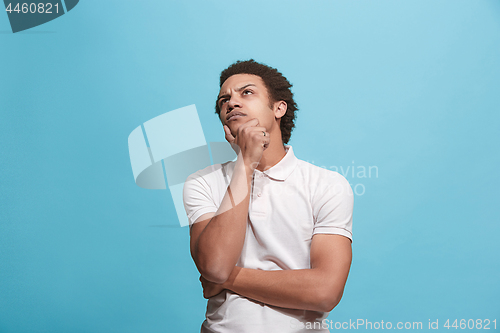 Image of Young serious thoughtful businessman. Doubt concept.