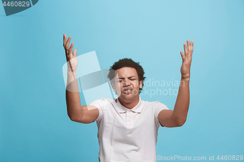 Image of Beautiful man looking suprised and bewildered isolated on blue