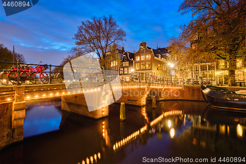 Image of Amterdam canal, bridge and medieval houses in the evening