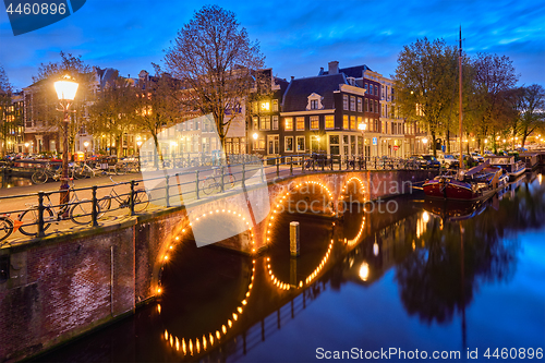 Image of Amterdam canal, bridge and medieval houses in the evening