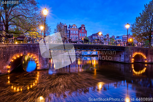 Image of Amterdam canal, bridge and medieval houses in the evening