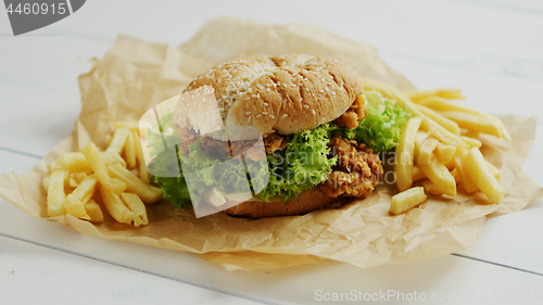 Image of French fries and burger on parchment