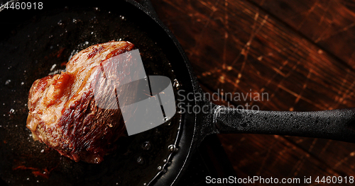 Image of Skillet with roasted meat on table