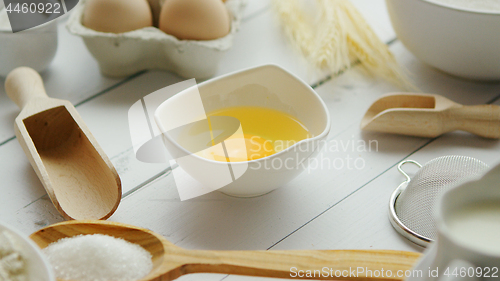 Image of Utensils and ingredient around bowl with yolk