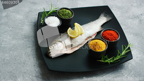Image of Spices lying on plate near fish