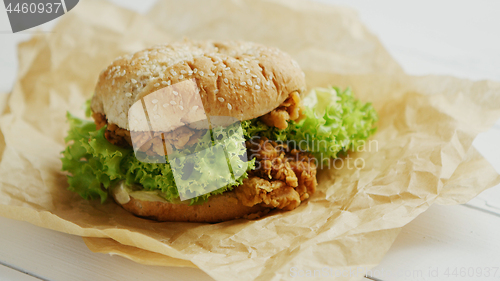 Image of Chicken burger lying on parchment