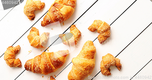 Image of Various croissants lying on table 