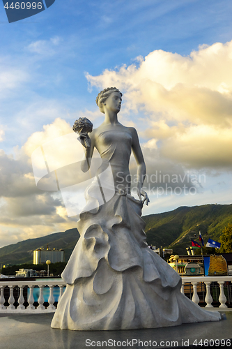 Image of Sculpture of bride girl in dress with bouquet of bride flowers