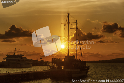 Image of Sailing ship in seaport at sunset