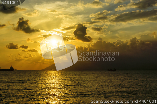 Image of Magnificent scenery and ships in sea at sunset