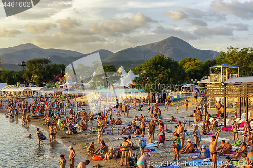 Image of A lot of resting people are on the sea beach