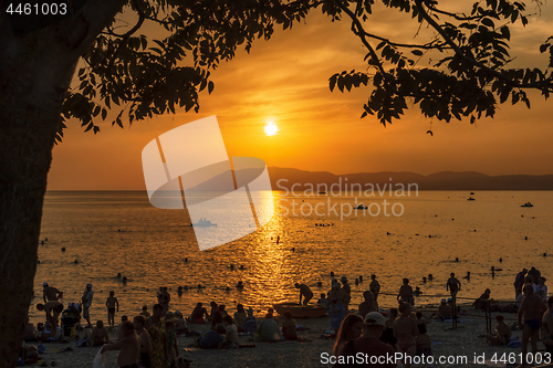 Image of Tourists enjoy the sunset on the beach on Black sea