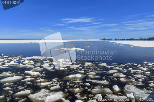 Image of Landscape of lumps of melting ice on lake in spring