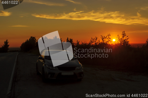 Image of Traveling car overnight stopover on roadside at sunset